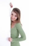 Happy Young Women Peeking Through A Blank Board Stock Photo