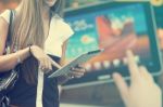 Young Woman With Tablet Computer Walking On Street Stock Photo