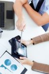 Executive Hands With Digital Tablet In A Financial Meeting Stock Photo