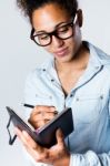 Pretty Young Black Woman Taking Notes At Home Stock Photo