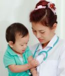 Baby And Female Doctor Stock Photo