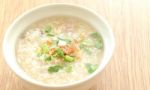 Congee Round Bowl On Wood Texture Tile Floor Stock Photo