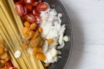 Close Up Raw Spaghetti With Fresh Vegetables In The Pan Stock Photo