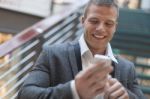 Happy Businessman With Smartphone In Business Building Stock Photo