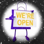 We're Open Sign On Shopping Bag Shows New Store Launch Or Openin Stock Photo