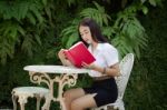 Thai Adult Student University Beautiful Girl Reading Red Book Stock Photo