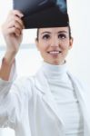 Attractive Young Female Doctor Examining X-ray Results Stock Photo