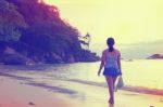 Tourist Girl Walking On The Beach Vintage Style Stock Photo