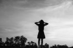 Silhouette Of Woman Praying Over Beautiful Sky Background Stock Photo