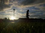 Silhouette  Running On Road At Sunrise Stock Photo