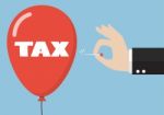 Hand Pushing Needle To Pop The Tax Balloon Stock Photo