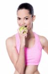 Beautiful Woman Biting Green Apple Stock Photo