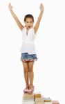 Young Child Standing On Books Stock Photo