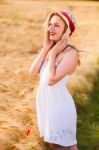 Lonely Beautiful Young Blonde Girl In White Dress With Straw Hat Stock Photo