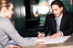 Colleagues Discussing Business Plan Stock Photo