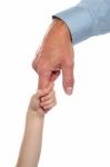 Child Holding Fathers Finger. Family Trust Stock Photo