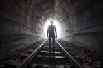 Man In A Tunnel Looking Towards The Light Stock Photo