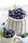 Blueberry Basket And Jug On White Wooden Table Stock Photo