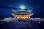 Gyeongbokgung Palace And Full Moon At Night In Seoul, South Korea Stock Photo