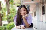 Portrait Of Thai High School Student Uniform Teen Beautiful Girl Using Her Phone And Smile Stock Photo