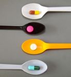 Four Spoons With Different Pills  Stock Photo