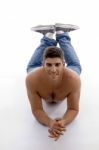 Muscular Male Model Lying And Looking At Camera Stock Photo