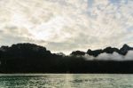 Sunrise Over The Mountains And Green Lake Stock Photo