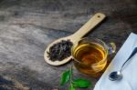 Glass Cup Of Tea And Spoons With Dried Leaves Tea Stock Photo