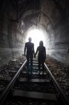 Couple Walking Together Through A Railway Tunnel Stock Photo