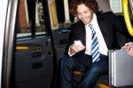 Man Messaging Through Cellphone Inside Taxi Cab Stock Photo