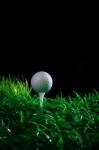 Golf Ball On Green Grass With Black Background Stock Photo