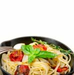 Spaghetti Pasta With Baked Cherry Tomatoes And Basil Stock Photo