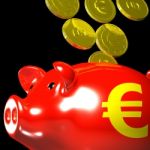 Coins Entering Piggybank Shows European Deposits Stock Photo