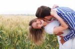 Happy Young Couple Hugging And Kissing Eachother Stock Photo