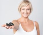 Woman Showing Polished Spa Stones Stock Photo