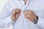 Businessman Buttoning Shirt Stock Photo