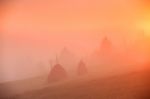 Sunrise Over Mountain Field. Haystacks In Misty Autumn Morning H Stock Photo