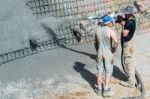 Worker Pumping Concrete Stock Photo