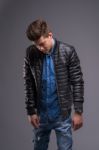 Casual Young Man In Black Leather Jacket And Denim Jeans Stock Photo