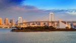 Rainbow Bridge And Tokyo Cityscape At Sunrise, Japan Stock Photo