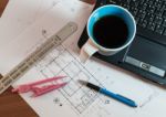 Cup Of Coffee On Laptop With Construction Plans Stock Photo