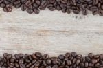 Coffee Bean On Grain Wood Stock Photo