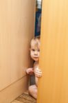 Curious Cute Baby Boy Looking Through Ajar Door Stock Photo