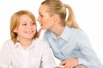 Mother Whispering To Son Close Up On White Background Stock Photo