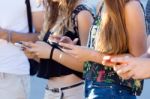 A Group Of Students Having Fun With Smartphones After Class Stock Photo