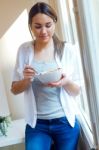 Beautiful Young Woman Eating Cereals At Home Stock Photo