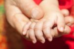 Mom Hand Holding Infant Hand Stock Photo