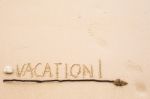 Inscription Of Vacation Written On Wet Yellow Beach Sand With Fo Stock Photo