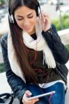 Beautiful Girl Listening To Music In City Stock Photo