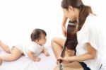 Mother Is Playing A Guitar For Her Baby Stock Photo